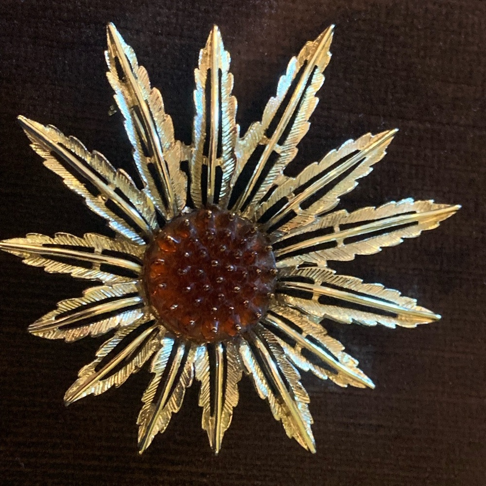 Vintage Brooch by Sarah Coventry. Bright mild Gold with brown center.